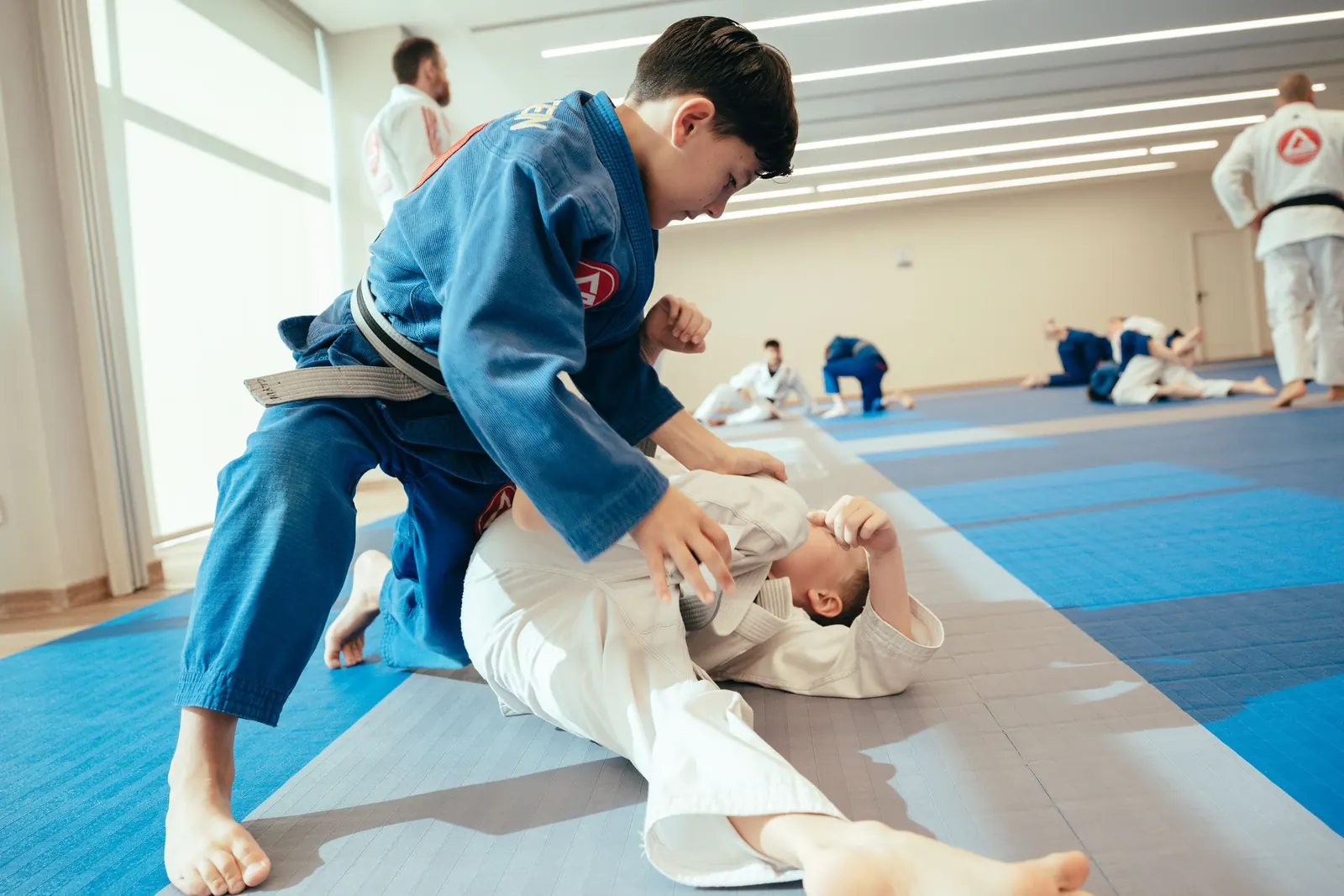 Two young students practising ground control on the mats