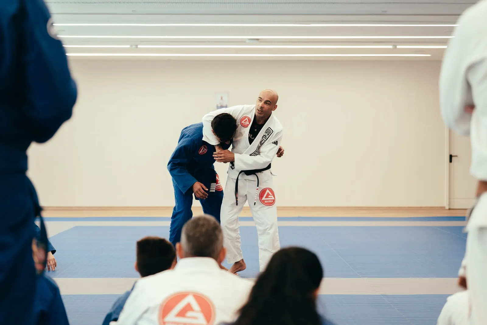 A Gracie Barra instructor demonstrating a Jiu-Jitsu technique to a student