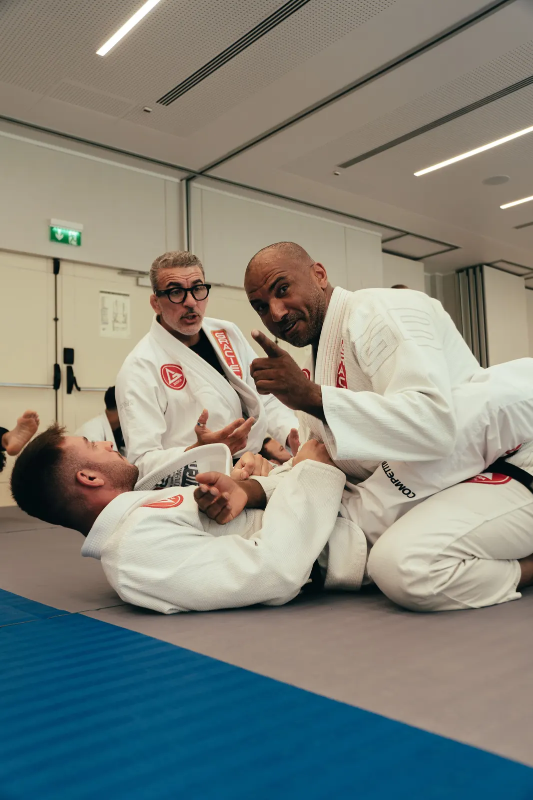 Adult Jiu-Jitsu students sharing a light moment on the mats
